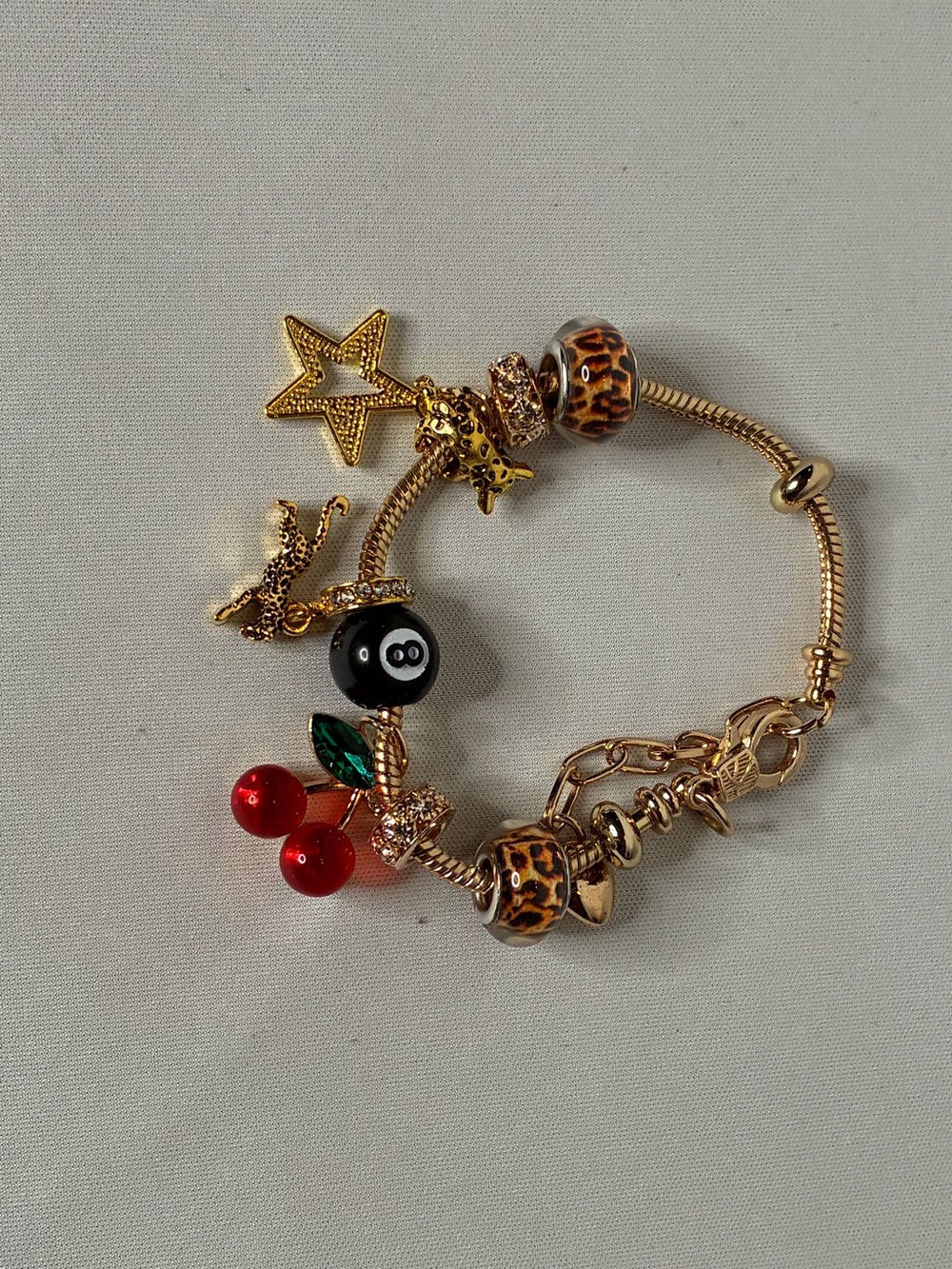 Gold Tone Charm Bracelet with Leopard Beads and Red Cherry Charm